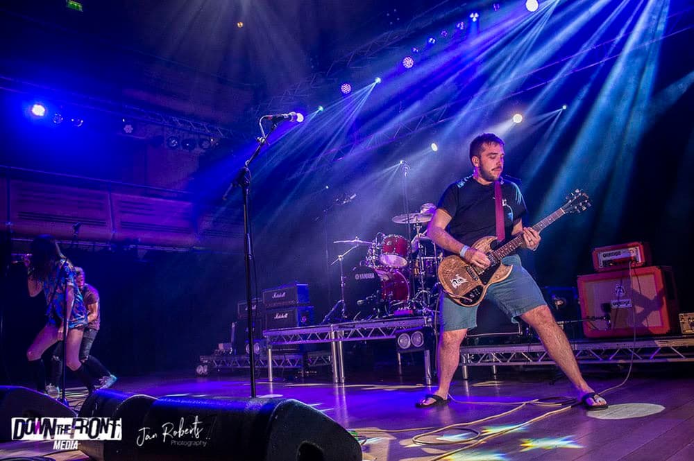 Dave Langdon playing guitar on stage with Underline The Sky at The Apex Bury St Edmunds Suffolk — gift industry sales rep in East Anglia