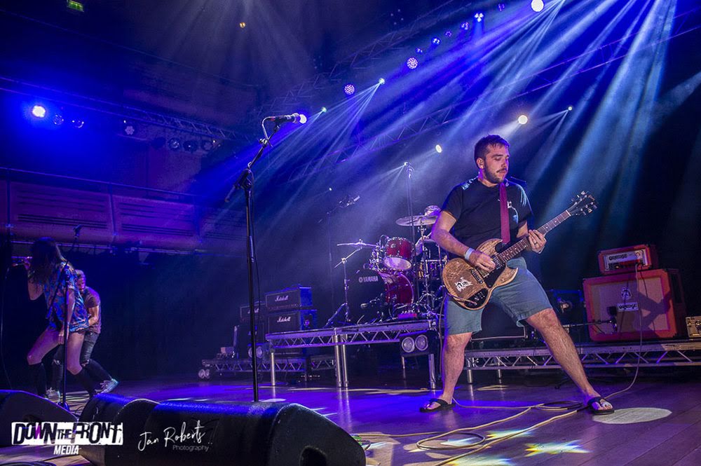 Dave Langdon playing guitar on stage with Underline The Sky at The Apex Bury St Edmunds Suffolk — gift industry sales rep in East Anglia