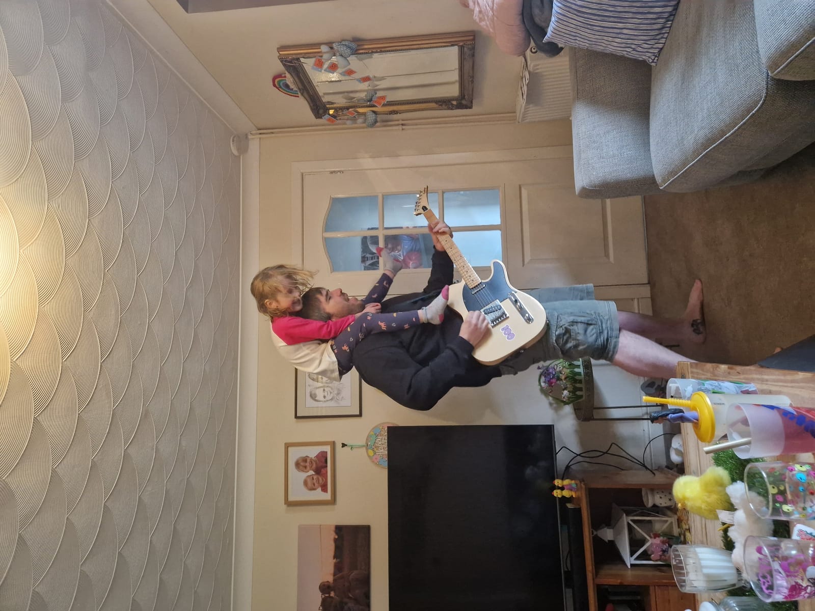 Dave Langdon practising guitar between East Anglia retailer visits — wholesale greeting card and gift sales agent Suffolk