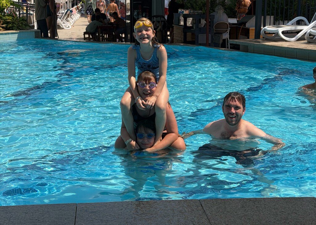 Dave Langdon’s children pulling off a triple-decker shower display in the pool — Ipswich based greeting card sales agent East Anglia